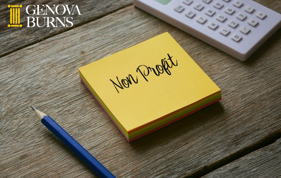 Yellow non profit sticky pad on wood table with calculator and pencil